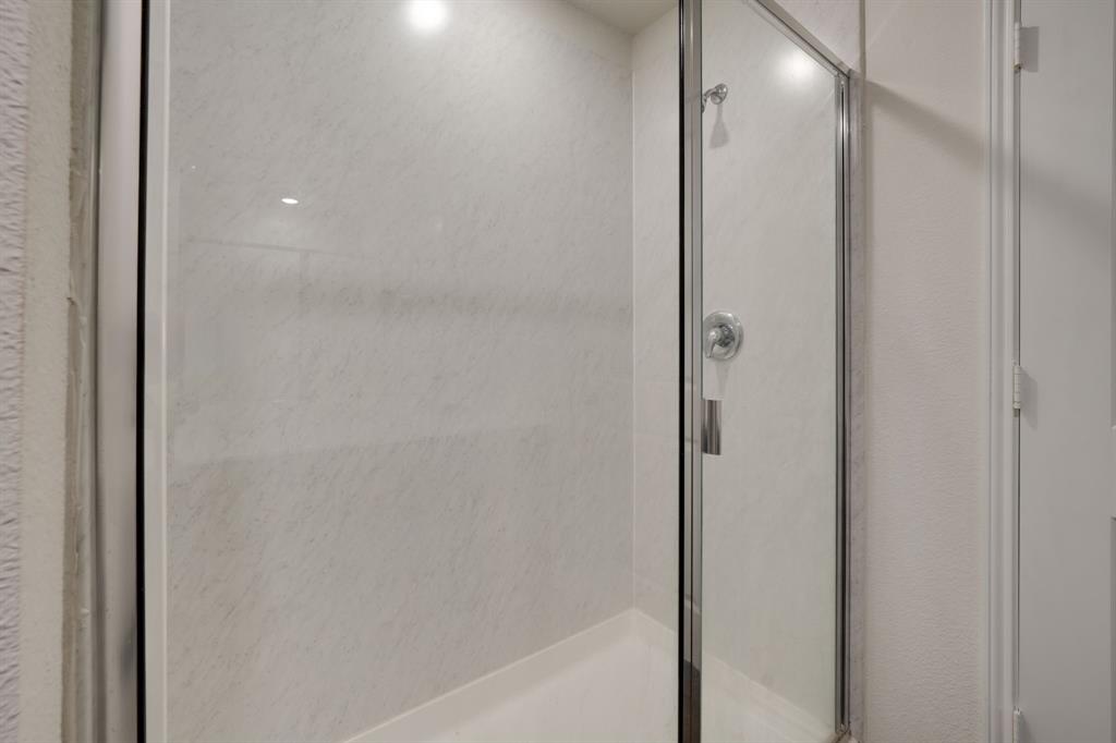 317 Sage Street Anna, TX 75409 - Photo 17 of 33 a bathroom with a glass shower door