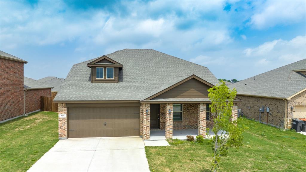 317 Sage Street Anna, TX 75409 - Photo 2 of 33 a front view of a house with a yard and garage