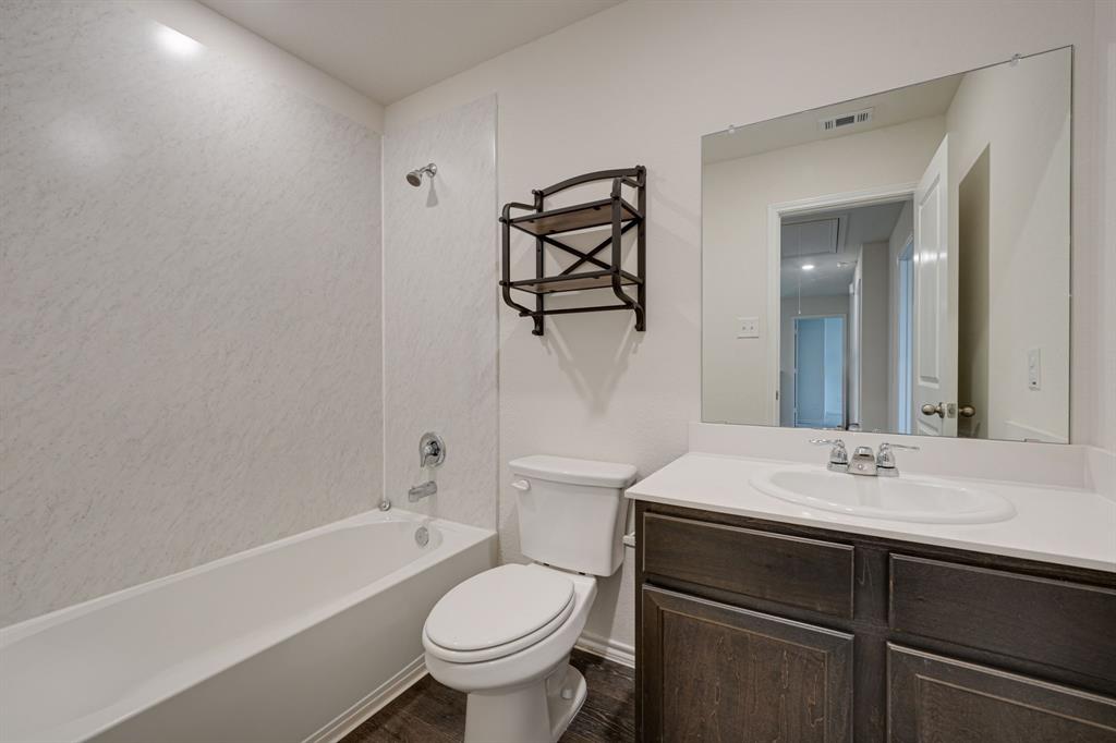 317 Sage Street Anna, TX 75409 - Photo 24 of 33 a bathroom with a sink a toilet and a bathtub