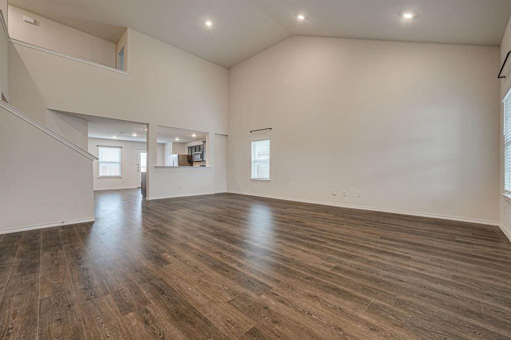 317 Sage Street Anna, TX 75409 - Photo 5 of 33 an empty room with wooden floor and windows