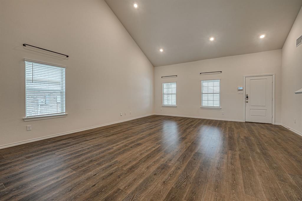 317 Sage Street Anna, TX 75409 - Photo 8 of 33 an empty room with wooden floor and windows
