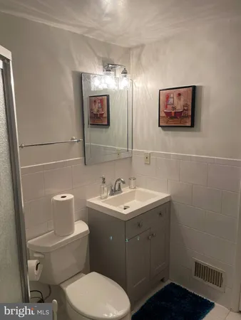 a bathroom with a toilet sink and mirror