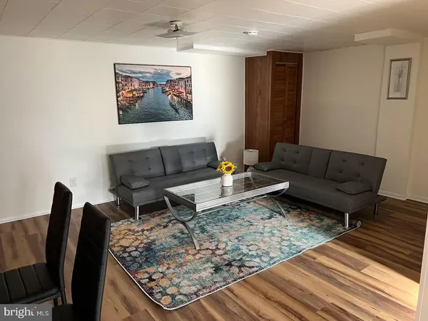 a living room with furniture and a rug