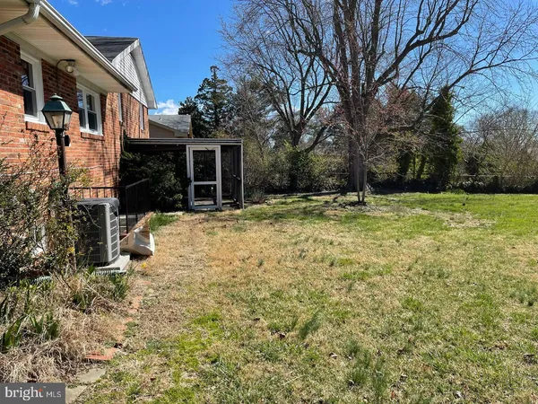 a view of a house with a yard covered in snow