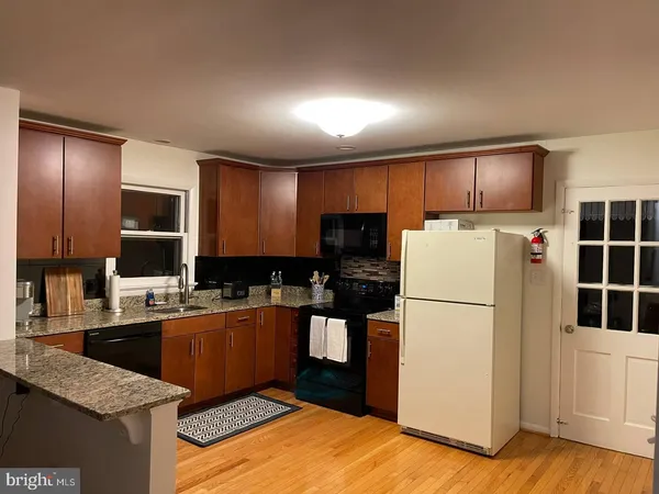 a kitchen with refrigerator and cabinets