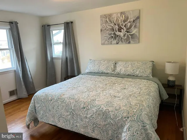 a large bed sitting in a bedroom next to a window