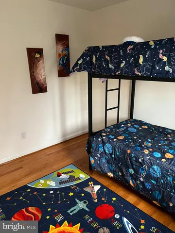 a bedroom with filled bed and furniture