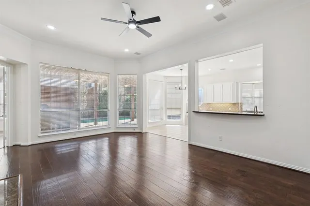 a view of a livingroom with hardwood floor and a ceiling fan