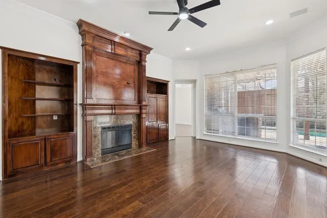 a living room with a fireplace and wooden floor