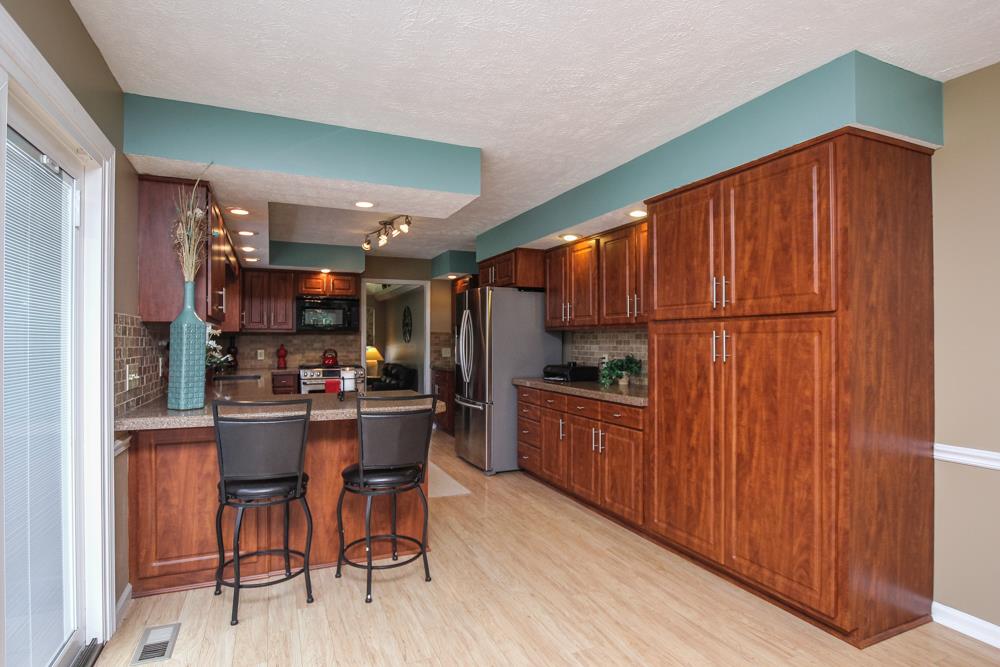 496 Horn Springs Road Lebanon, TN 37087 - Photo 13 of 30 a kitchen with granite countertop wooden cabinets and stainless steel appliances