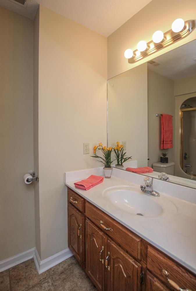 496 Horn Springs Road Lebanon, TN 37087 - Photo 25 of 30 a bathroom with a granite countertop sink and a mirror