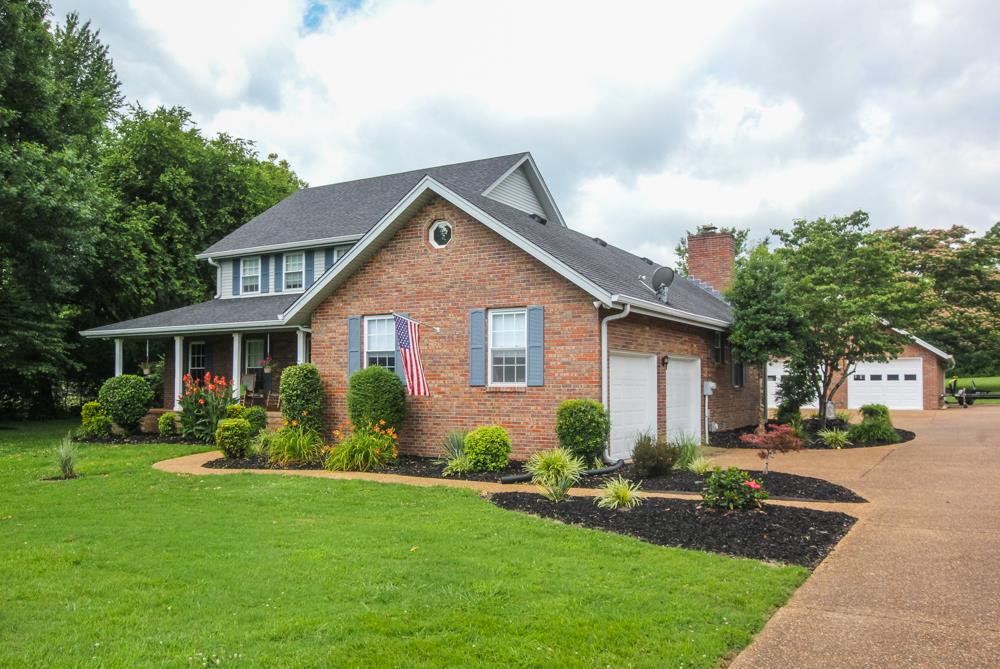 496 Horn Springs Road Lebanon, TN 37087 - Photo 3 of 30 a front view of a house with a garden and plants