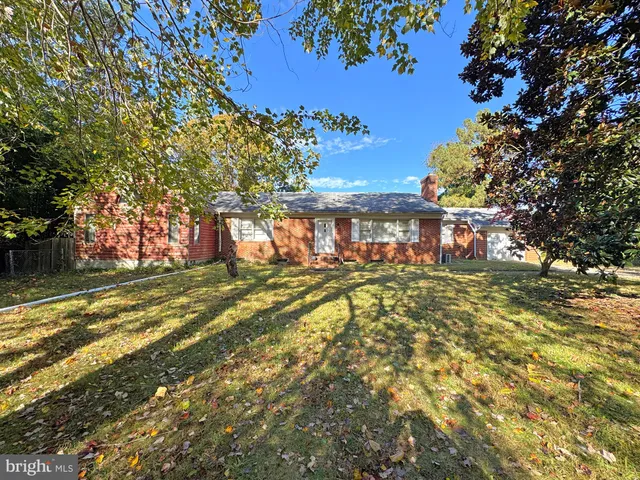 a view of a house with a large tree