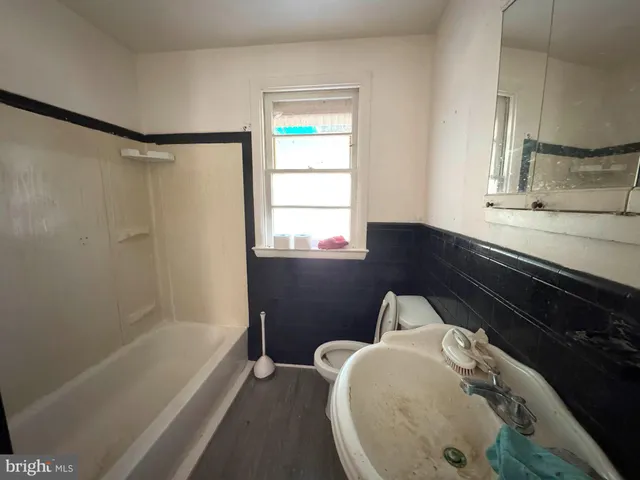 a bathroom with a bathtub and a window
