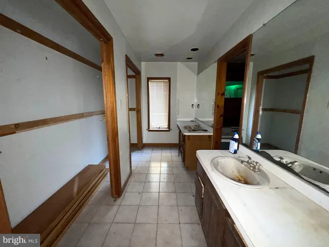 a bathroom with a sink a mirror and a bathtub