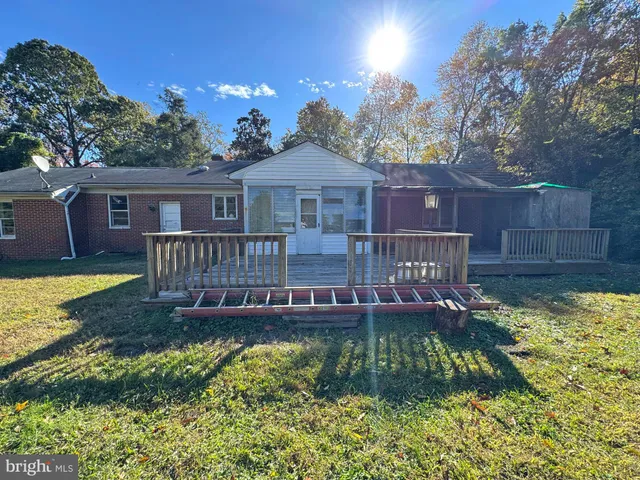 a view of a house with swimming pool next to a yard