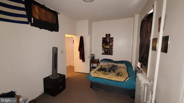 a bedroom with furniture and a window