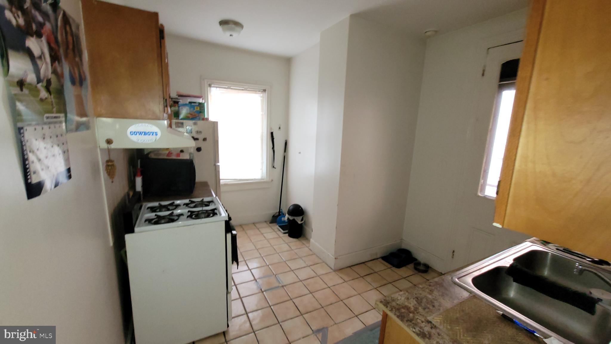 146 North 5th Street Reading, PA 19601 - Photo 12 of 53 a bedroom with a bed and a stove top oven