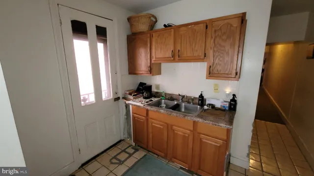 a kitchen with sink cabinets and stove top oven