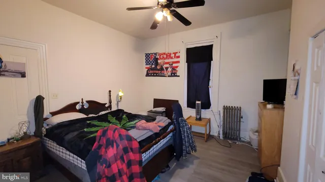 a view of hallway with furniture and wooden floor