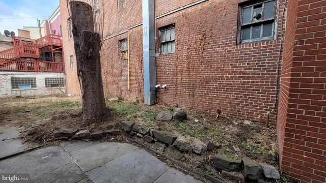 a view of a brick house with a yard