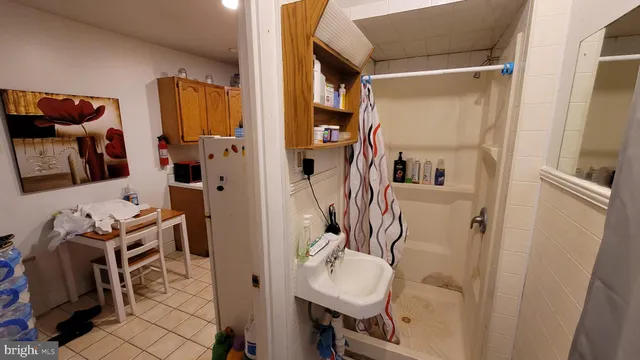 a view of an empty room with wooden floor and closet