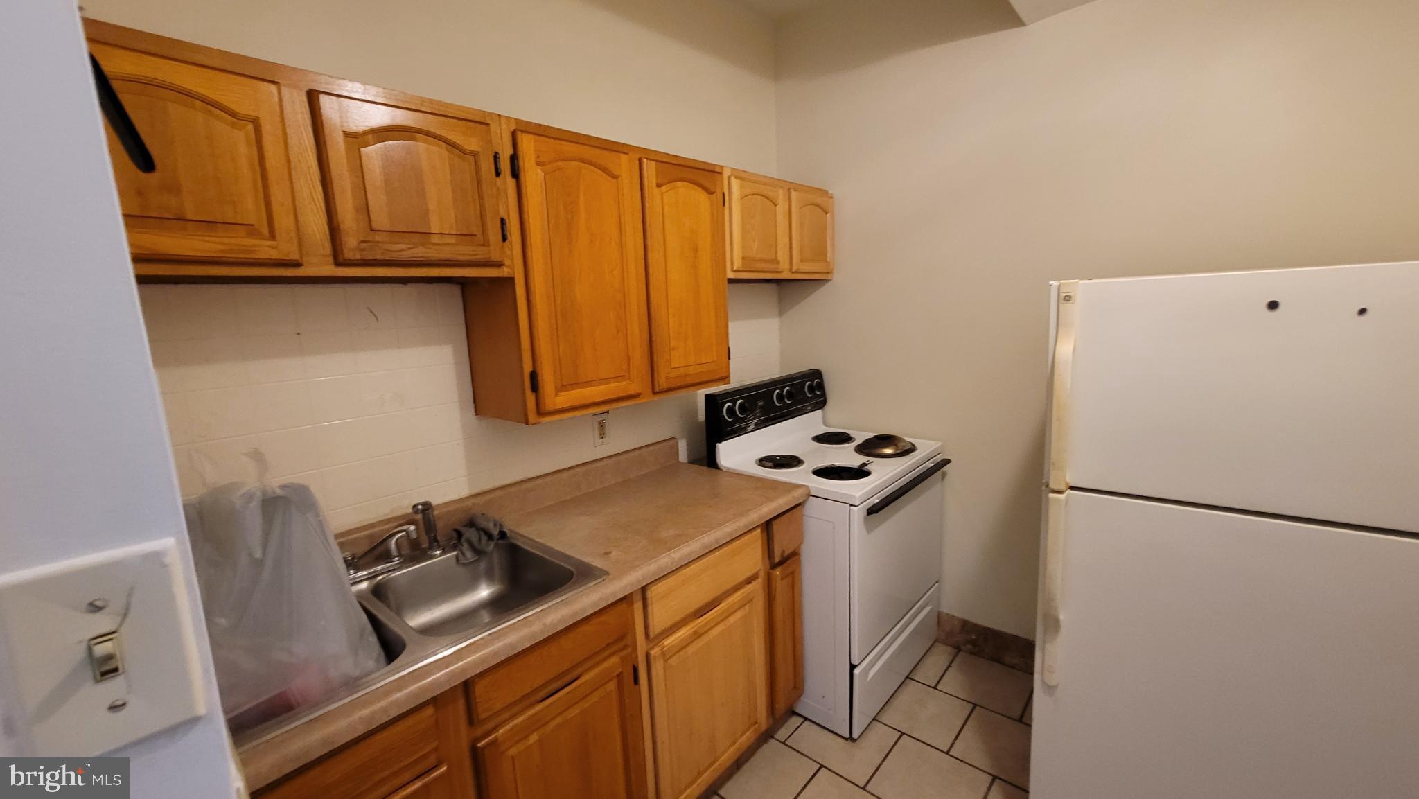 146 North 5th Street Reading, PA 19601 - Photo 40 of 53 a kitchen with stainless steel appliances a stove a refrigerator and a sink