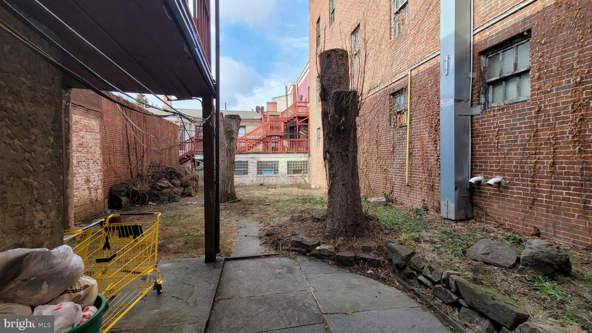 146 North 5th Street Reading, PA 19601 - Photo 4 of 53 a view of a patio with table and chairs and floor to ceiling window