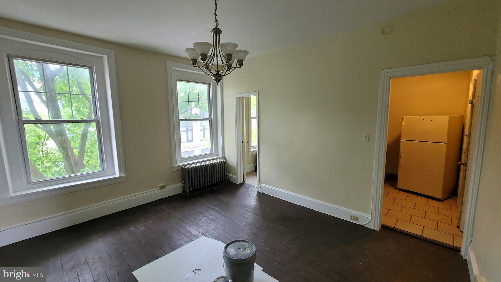 146 North 5th Street Reading, PA 19601 - Photo 41 of 53 a view of an empty room with wooden floor and a window