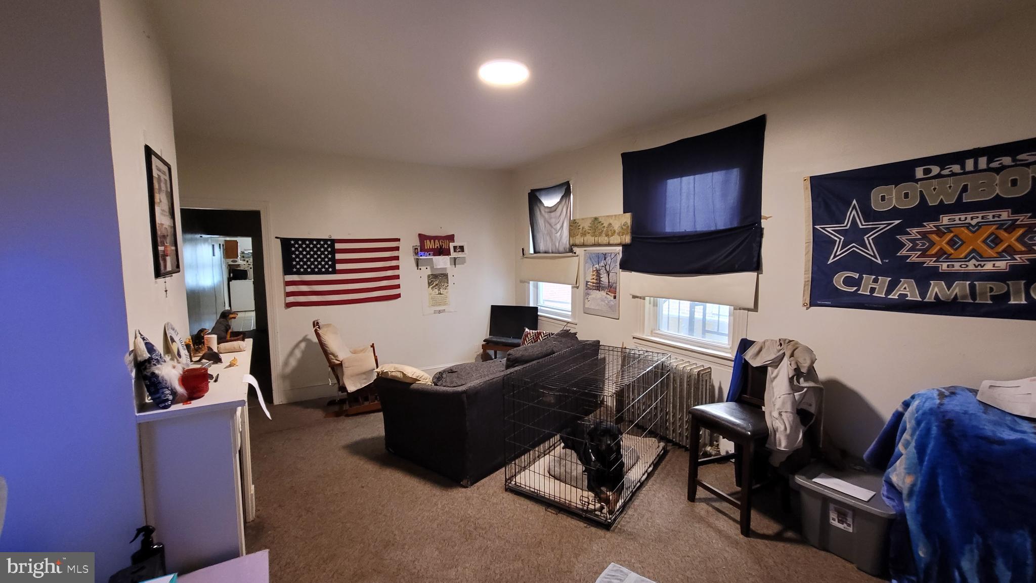 146 North 5th Street Reading, PA 19601 - Photo 7 of 53 a living room with furniture a flat screen tv and kitchen view