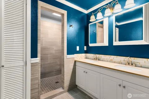 a bathroom with a shower sink and mirror
