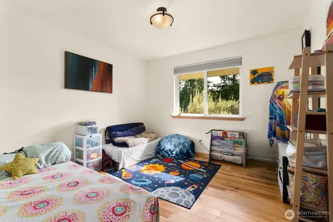 a bedroom with furniture and a flat screen tv