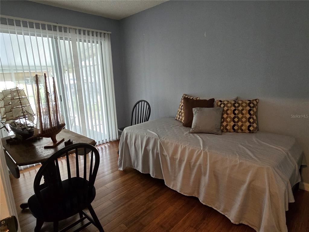 24521 Alligator Road Astor, FL 32102 - Photo 12 of 18 a bedroom with two beds and a chair