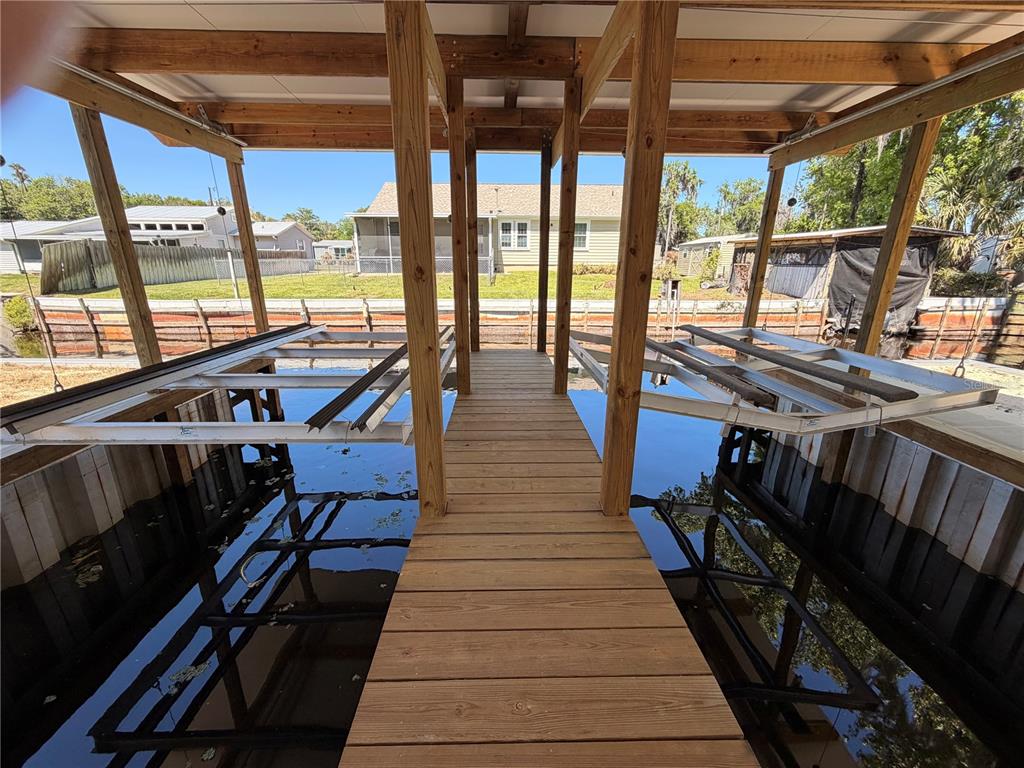 24521 Alligator Road Astor, FL 32102 - Photo 17 of 24 a view of a balcony with chairs and wooden floor