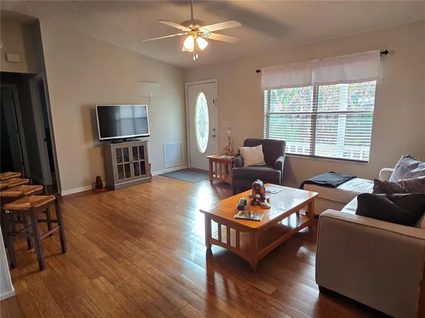 a living room with furniture a window and a flat screen tv