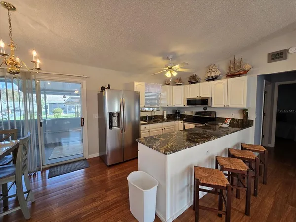 a large kitchen with a table and chairs