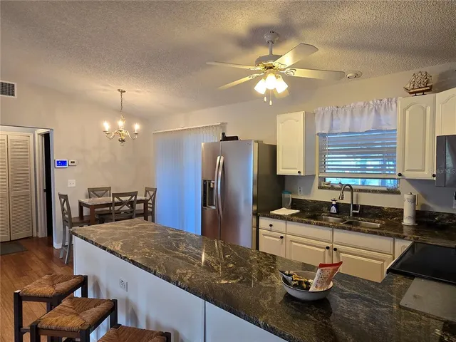 a kitchen with a refrigerator and a sink