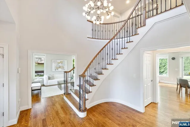 a view of entryway and hall with wooden floor