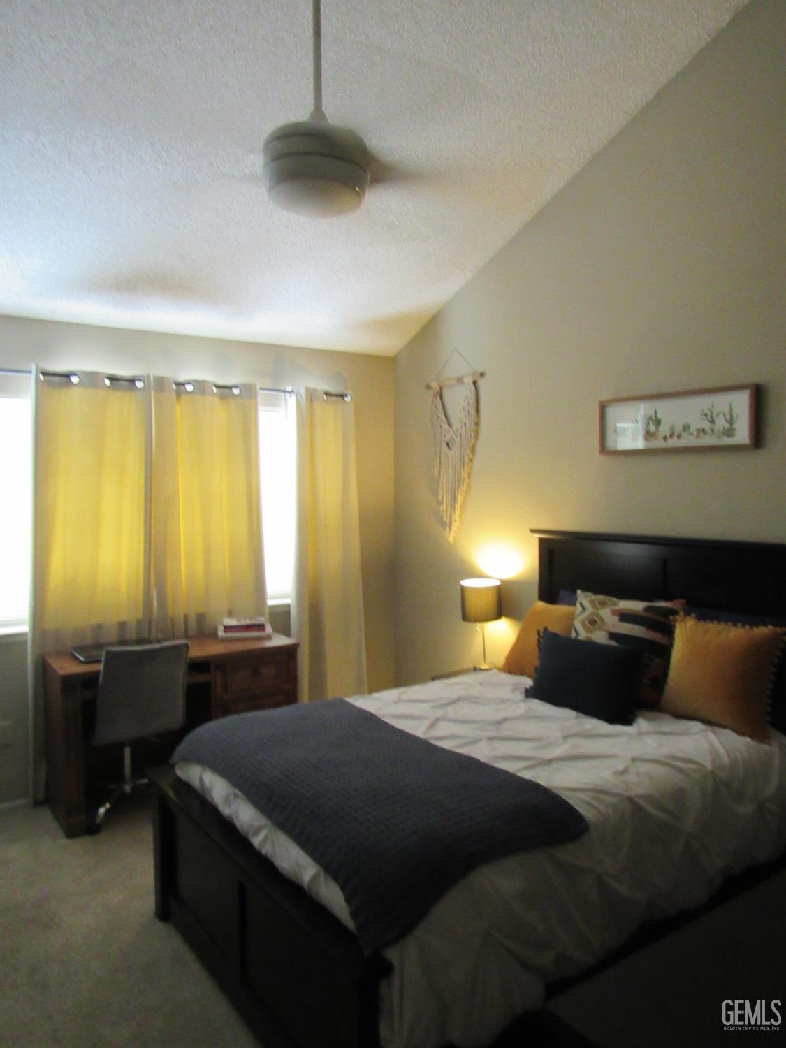 Undisclosed Address Bakersfield, CA 93309 - Photo 13 of 25 a bedroom with a bed and a chandelier