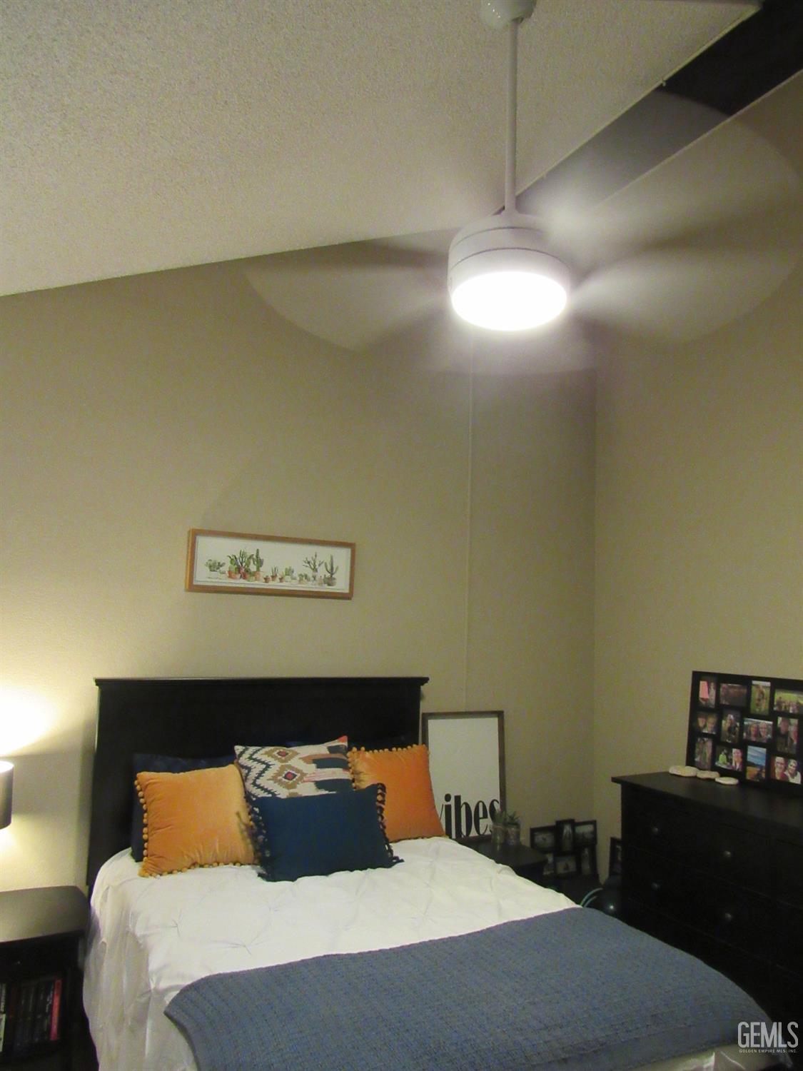 Undisclosed Address Bakersfield, CA 93309 - Photo 14 of 25 a bedroom with a bed and a lamp on the dresser