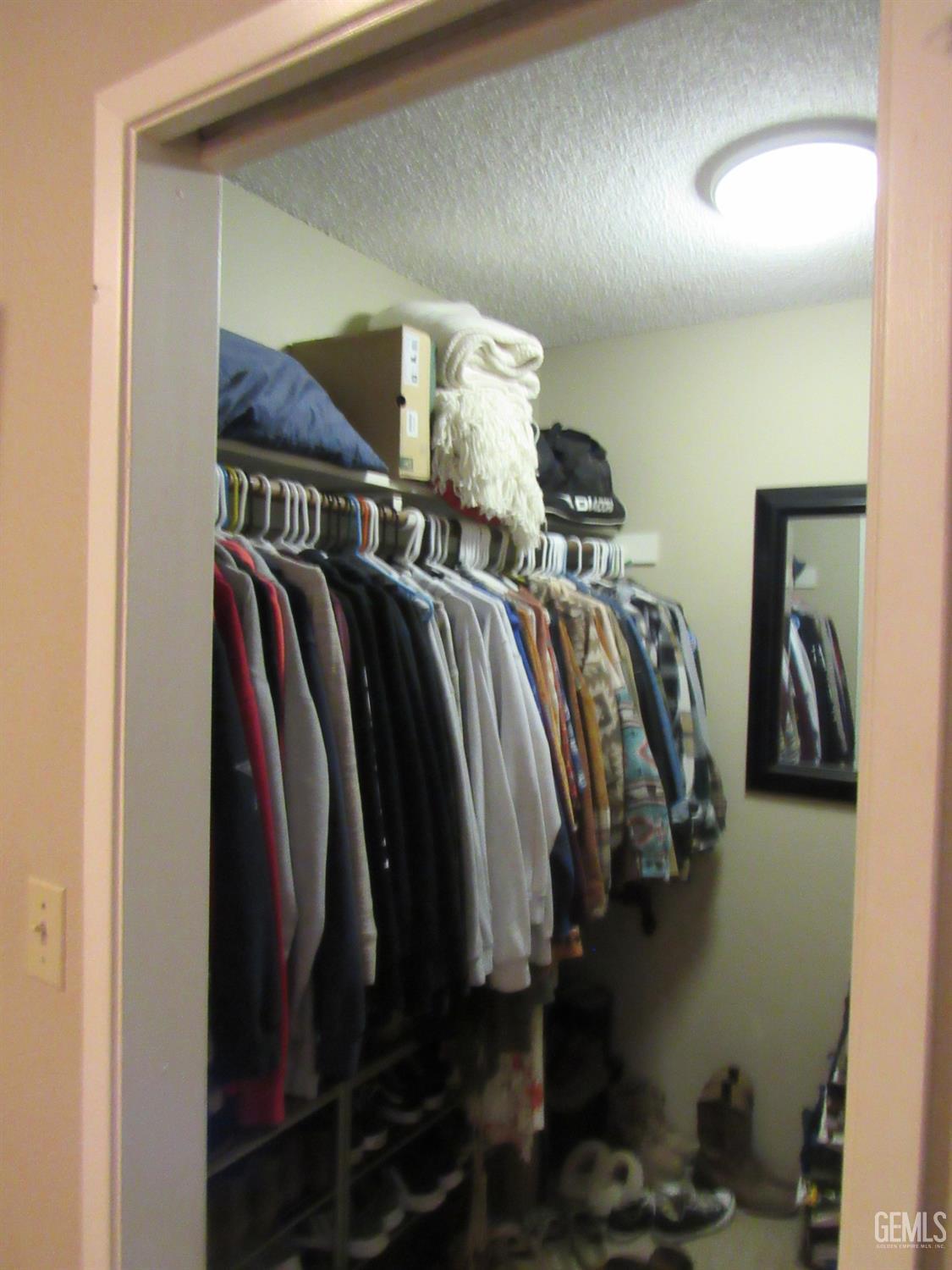 Undisclosed Address Bakersfield, CA 93309 - Photo 16 of 25 a view of walk in closet with clothes and shoes