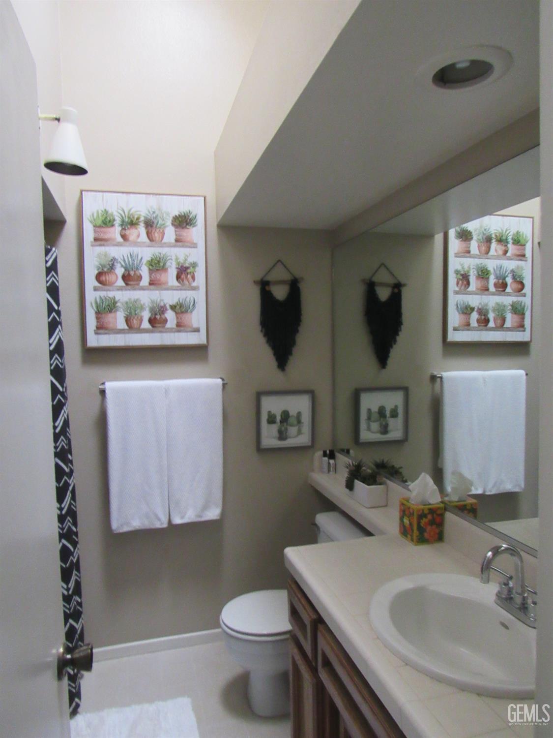 Undisclosed Address Bakersfield, CA 93309 - Photo 18 of 25 a bathroom with a sink mirror and toilet
