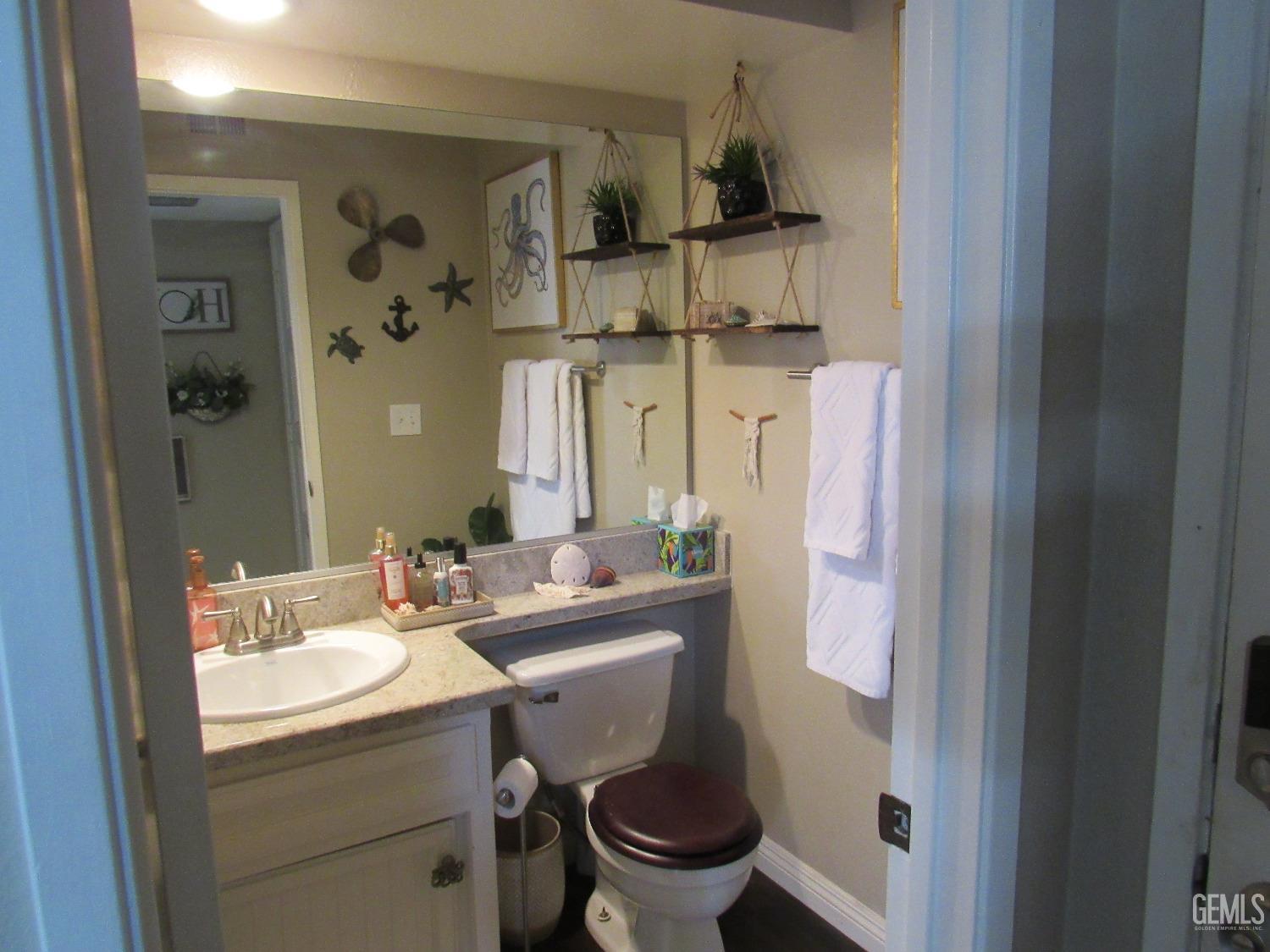 Undisclosed Address Bakersfield, CA 93309 - Photo 19 of 25 a bathroom with a sink toilet and a mirror
