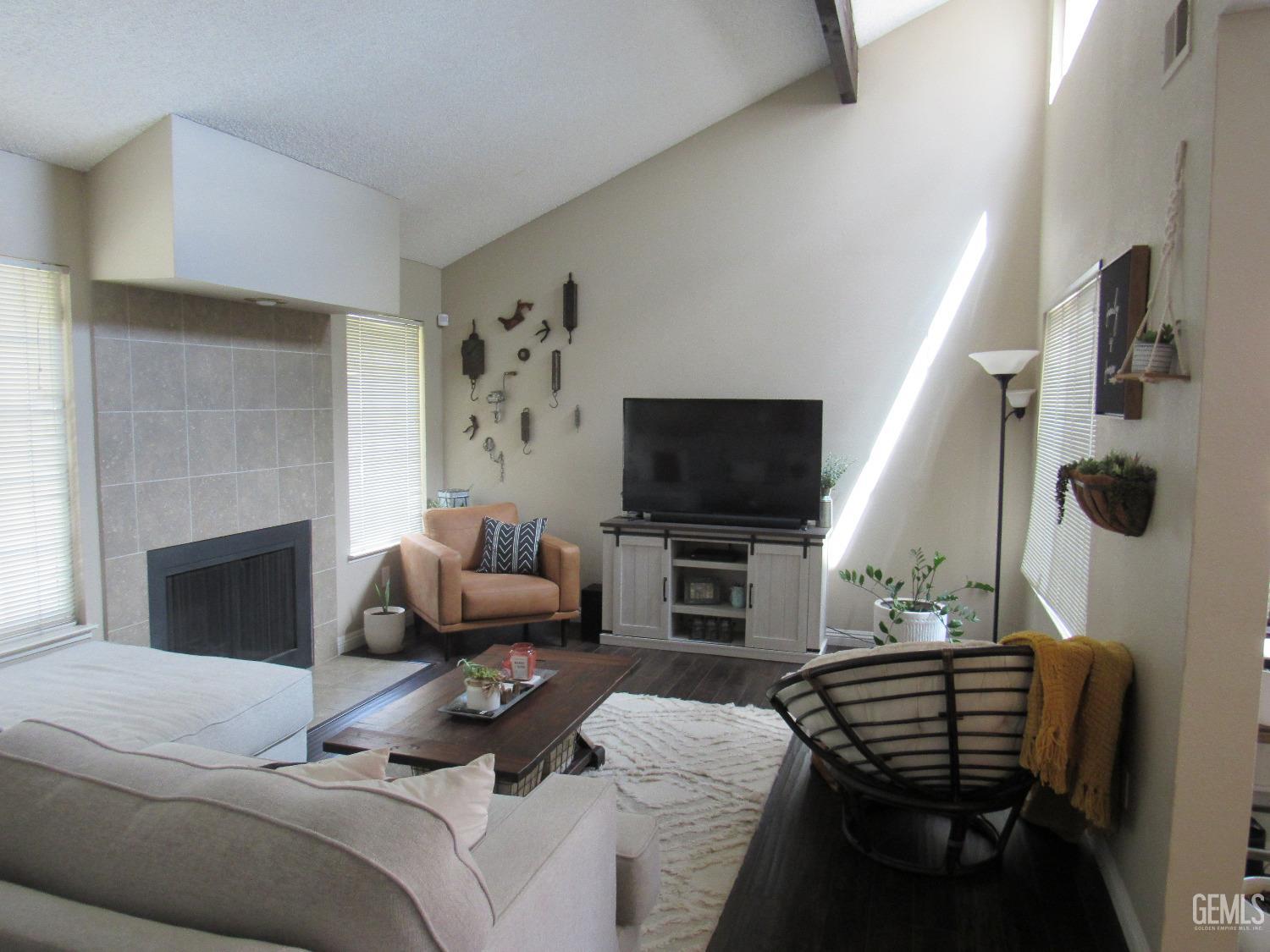 Undisclosed Address Bakersfield, CA 93309 - Photo 2 of 25 a living room with furniture and a flat screen tv