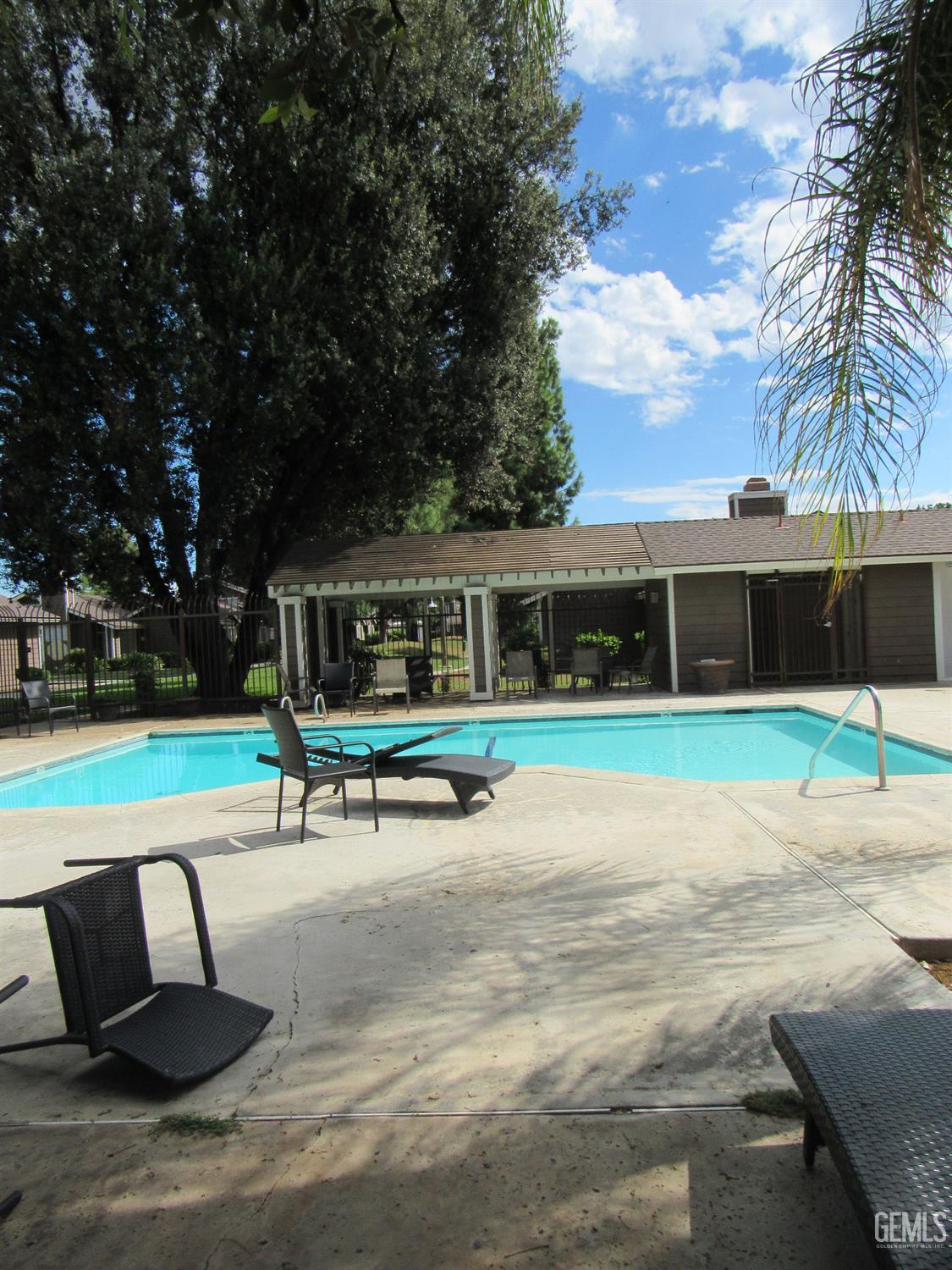 Undisclosed Address Bakersfield, CA 93309 - Photo 24 of 25 a park bench sitting in the middle of a park