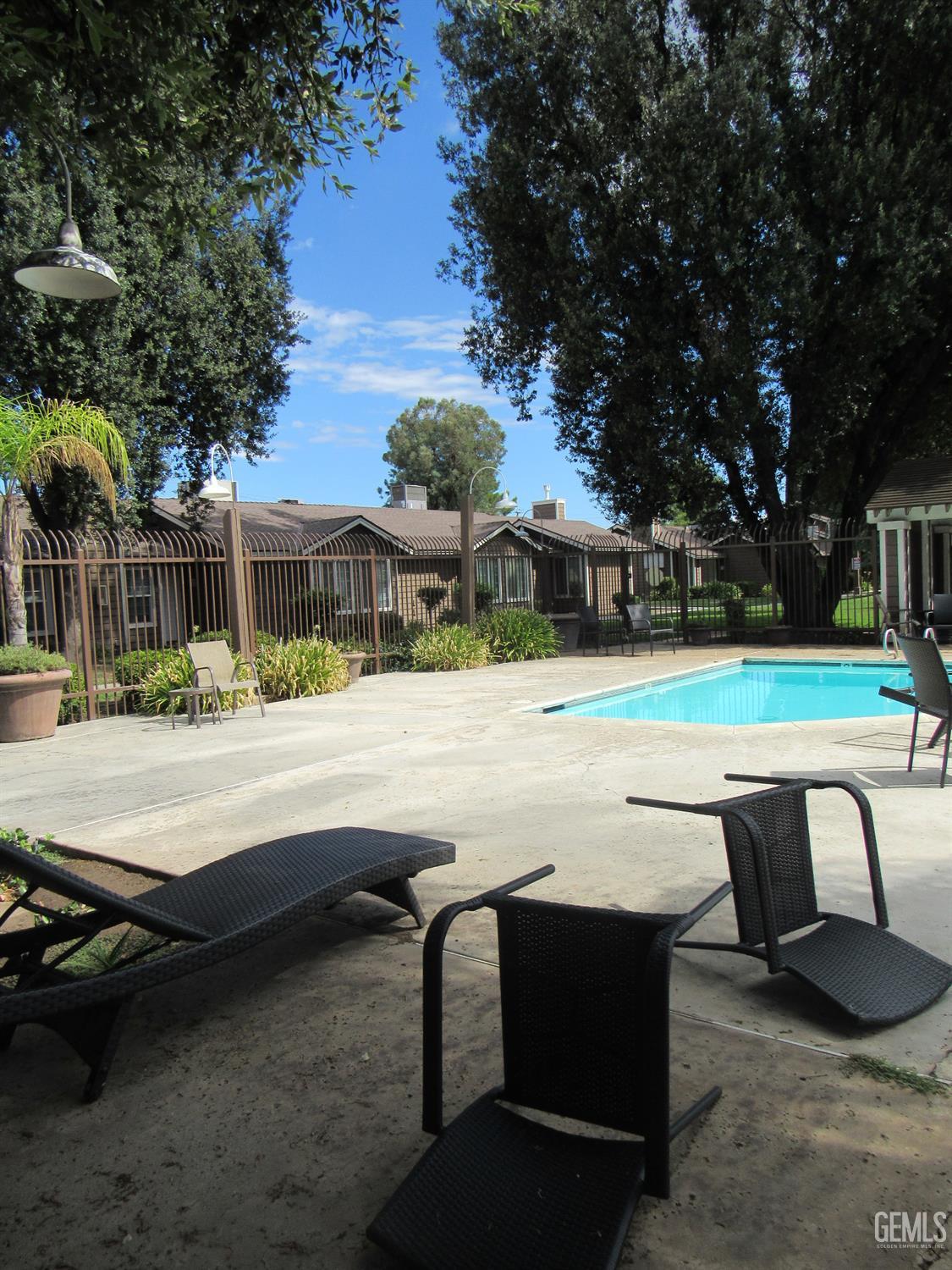 Undisclosed Address Bakersfield, CA 93309 - Photo 25 of 25 a swimming pool with outdoor seating and yard