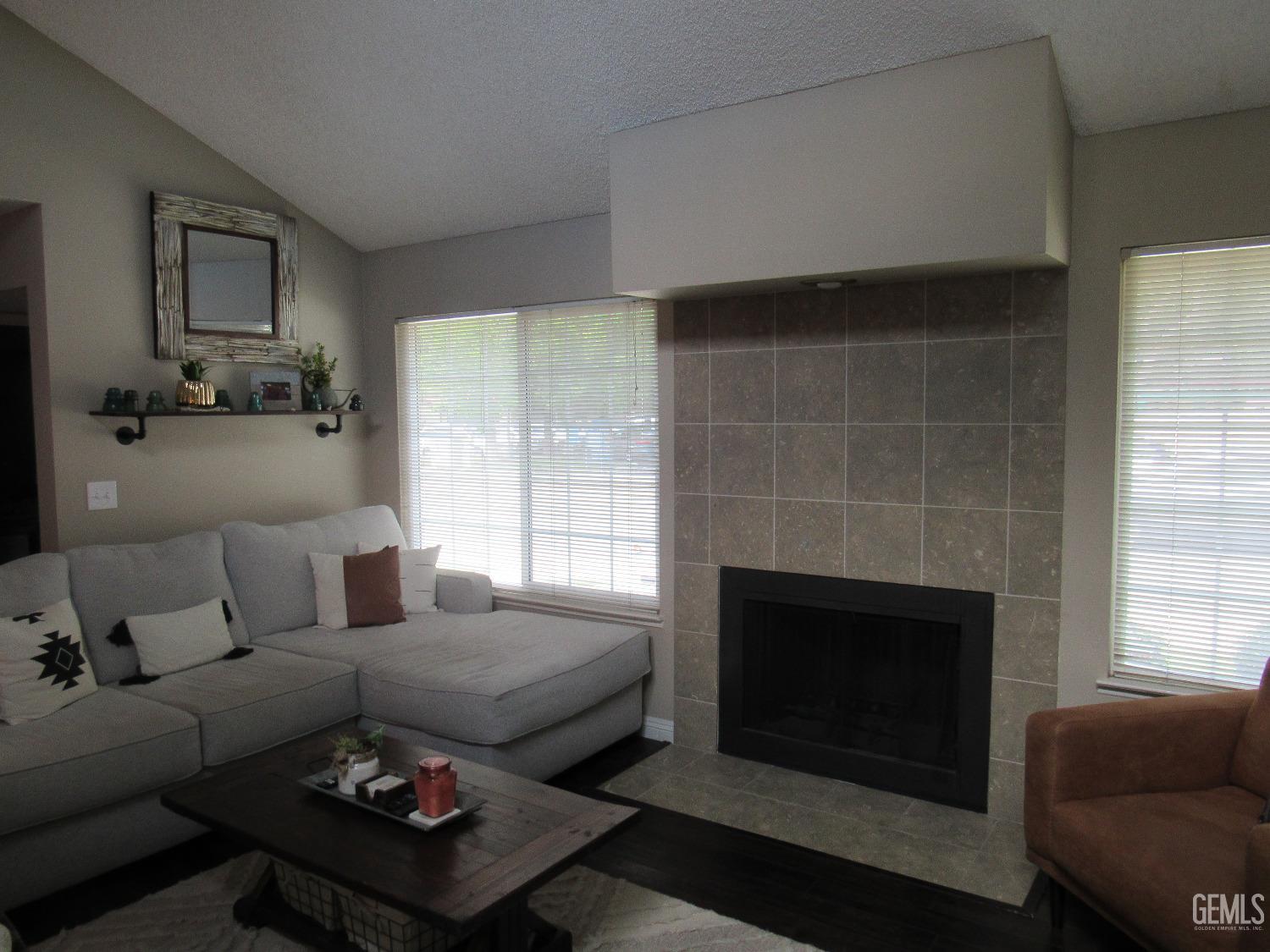 Undisclosed Address Bakersfield, CA 93309 - Photo 3 of 25 a living room with furniture and a fireplace
