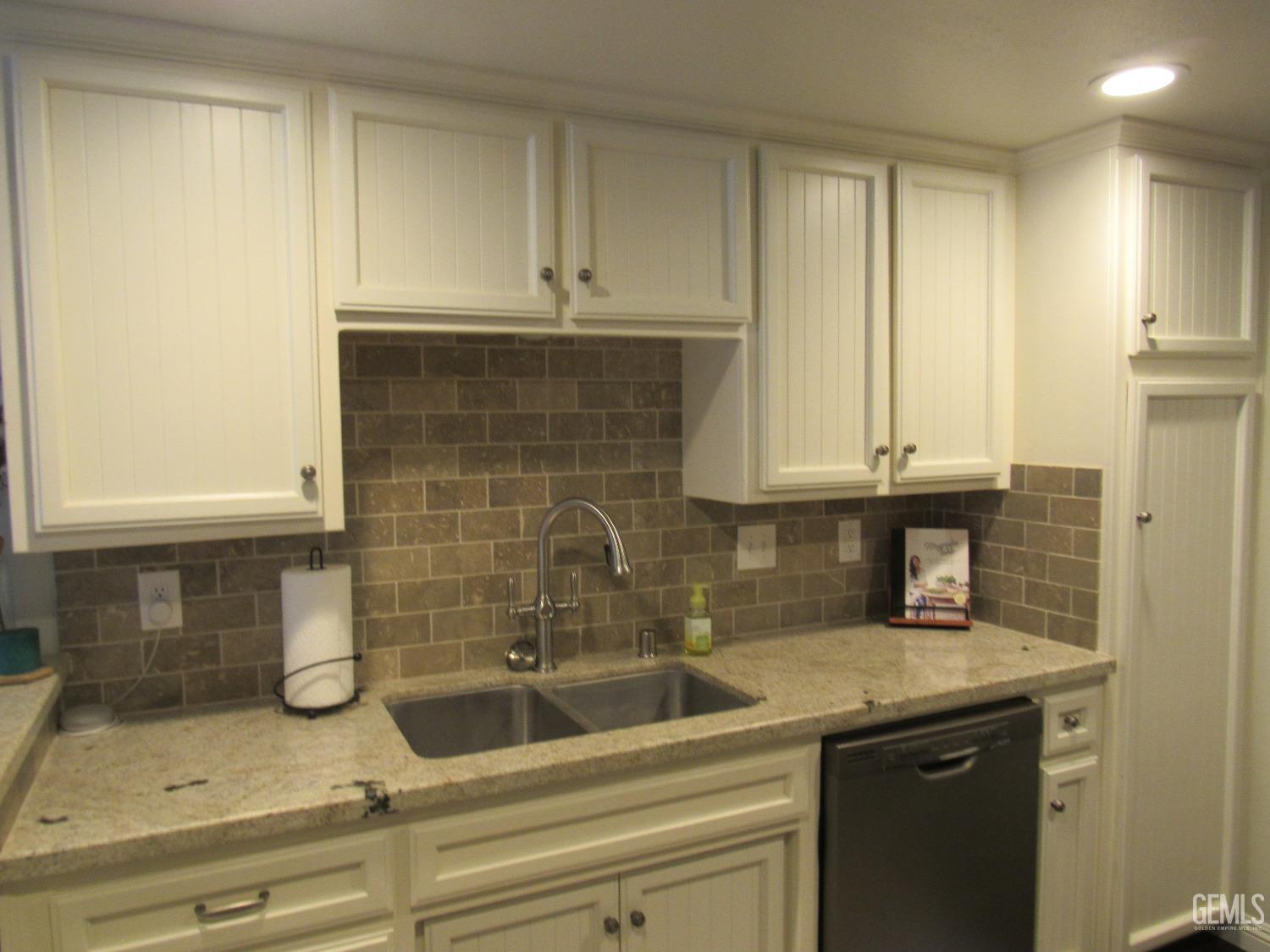 Undisclosed Address Bakersfield, CA 93309 - Photo 6 of 25 a kitchen with a sink and cabinets