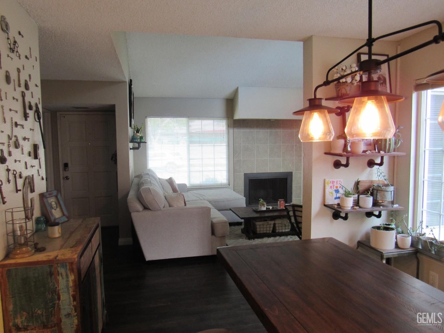 Undisclosed Address Bakersfield, CA 93309 - Photo 8 of 25 a living room with furniture a fireplace and a flat screen tv