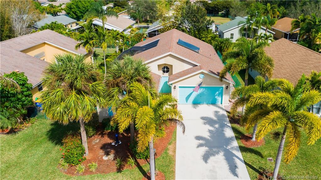 2441 Southwest Omega Way Stuart, FL 34997 - Photo 2 of 37 Courtyard style home surrounded by Palm Tree Landscape